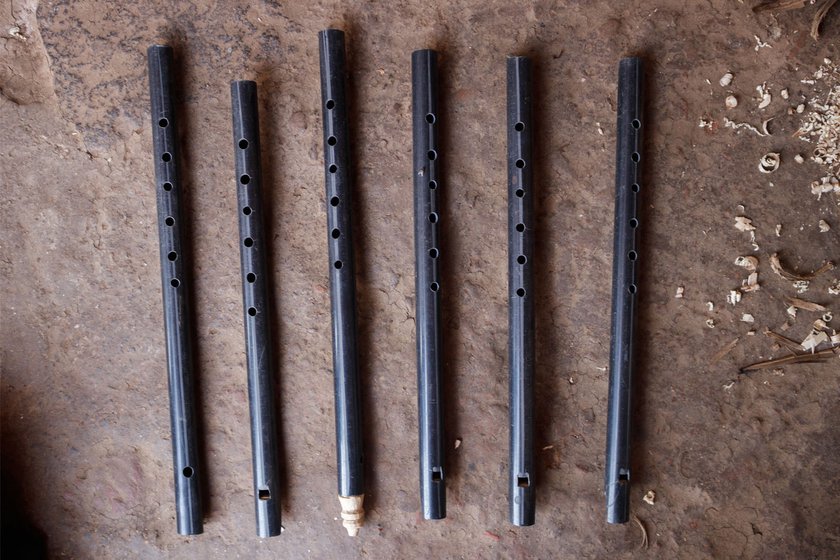 Left: Narayan started making these black and blue PVC ( Polyvinyl Chloride) three years ago as demand for wooden flutes reduced due to high prices.