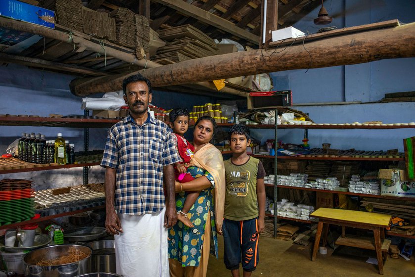 Thiru and Gomathy with their children in the workshop, behind their living room.