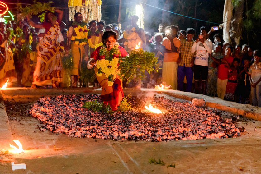 Right: K. Kanniamma tries to sit briefly in the fire pit before crossing. This is a risky move for those who attempt as one needs to be fast enough not to burn one's feet. Kanniamma's b rother Manigandan followed this tradition every year until their father's death. Since no male member of the family could sit, Kanniamma took it on herself.