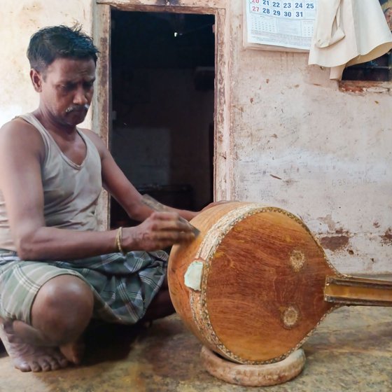 Right: Craftsman Murugesan working on a veenai