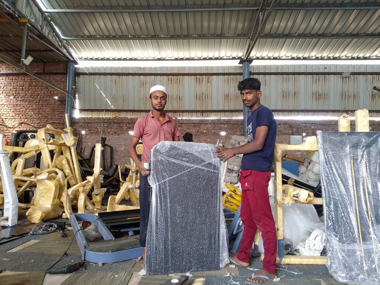 Right: Sameer Abbasi (pink t-shirt) and Mohsin Qureshi pack individual parts of gym equipment