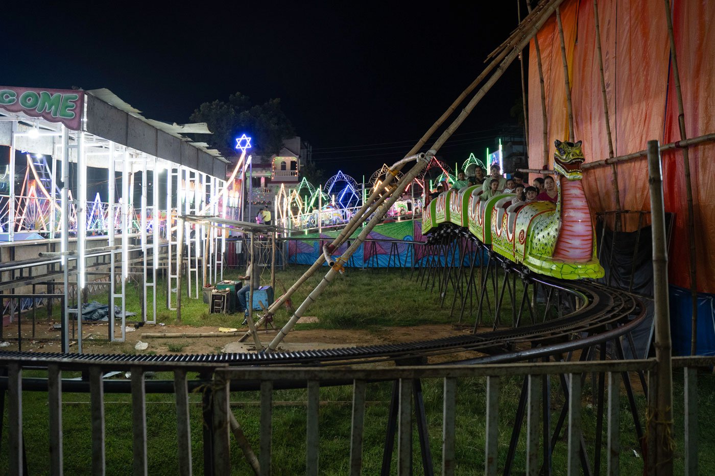 The maut-ka-kuan is one of many attractions at this Durga Puja mela in October 2023 in Agartala, Tripura. Other attractions include a ferris wheel, merry-go-round and toy-trains