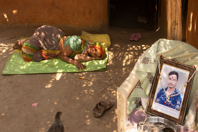 Right: Sapna Ben Katara lying in the courtyard near the photo of deceased Paresh