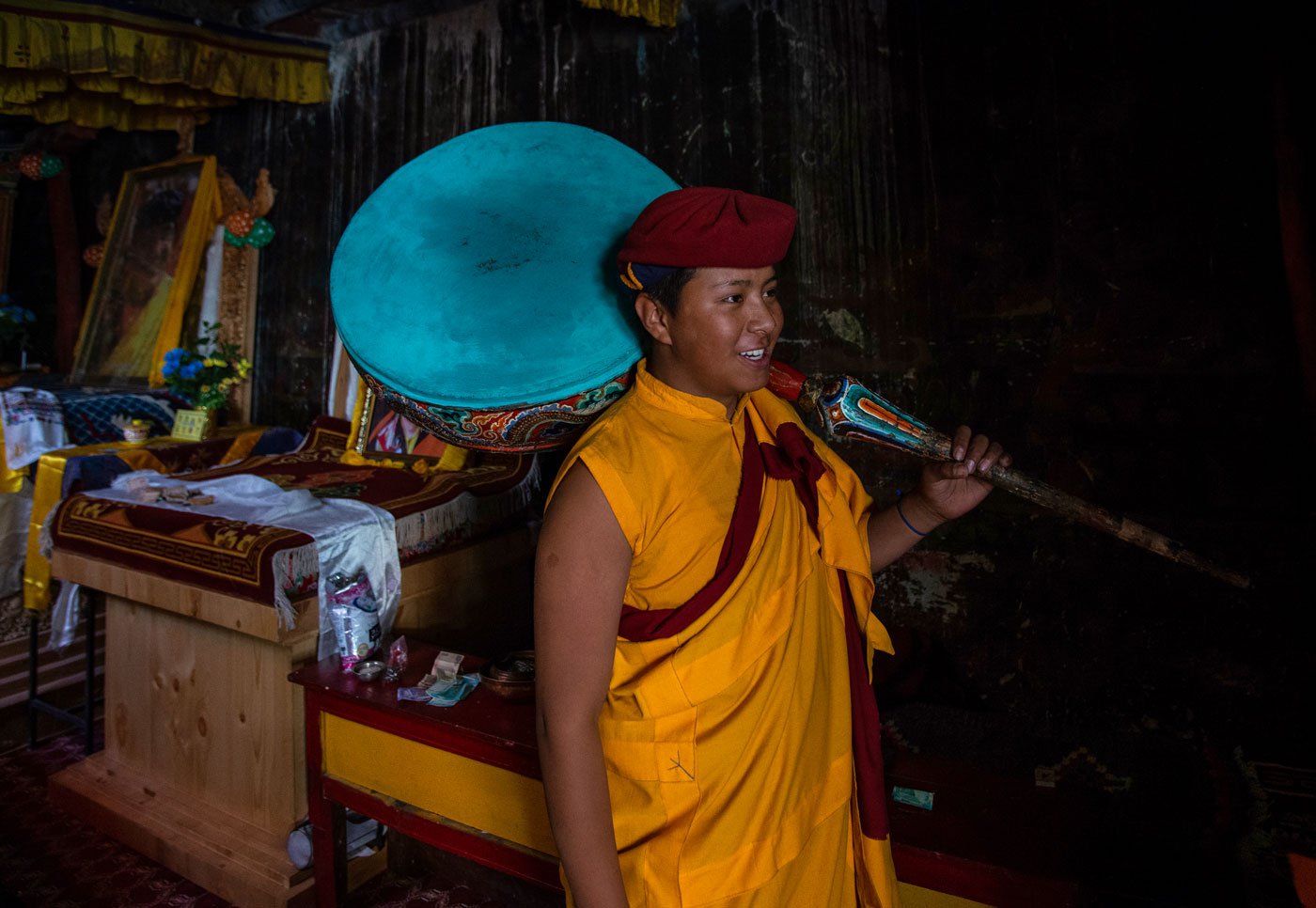 Lama Dorje Tesring holding a traditional musical instrument called ang