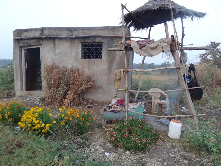 Ramchandra Dodake (right) at the break of the dawn, on his farm after the night vigil