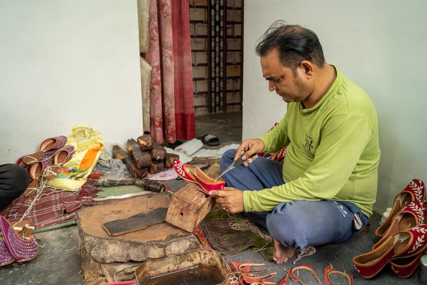 Young shoemakers like Raj Kumar (left) say that artificial leather is now more commonly used for making juttis . In Guru Ravidas Colony in Malout where he lives and works, tanneries have shut