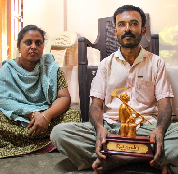 Gomathy and Thiru with an award they received for organic farming