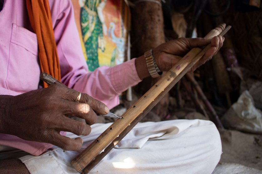 Narayan marks the tone holes (left) of a flute using the wooden reference scale he made and then checks if it is producing the right tones (right)