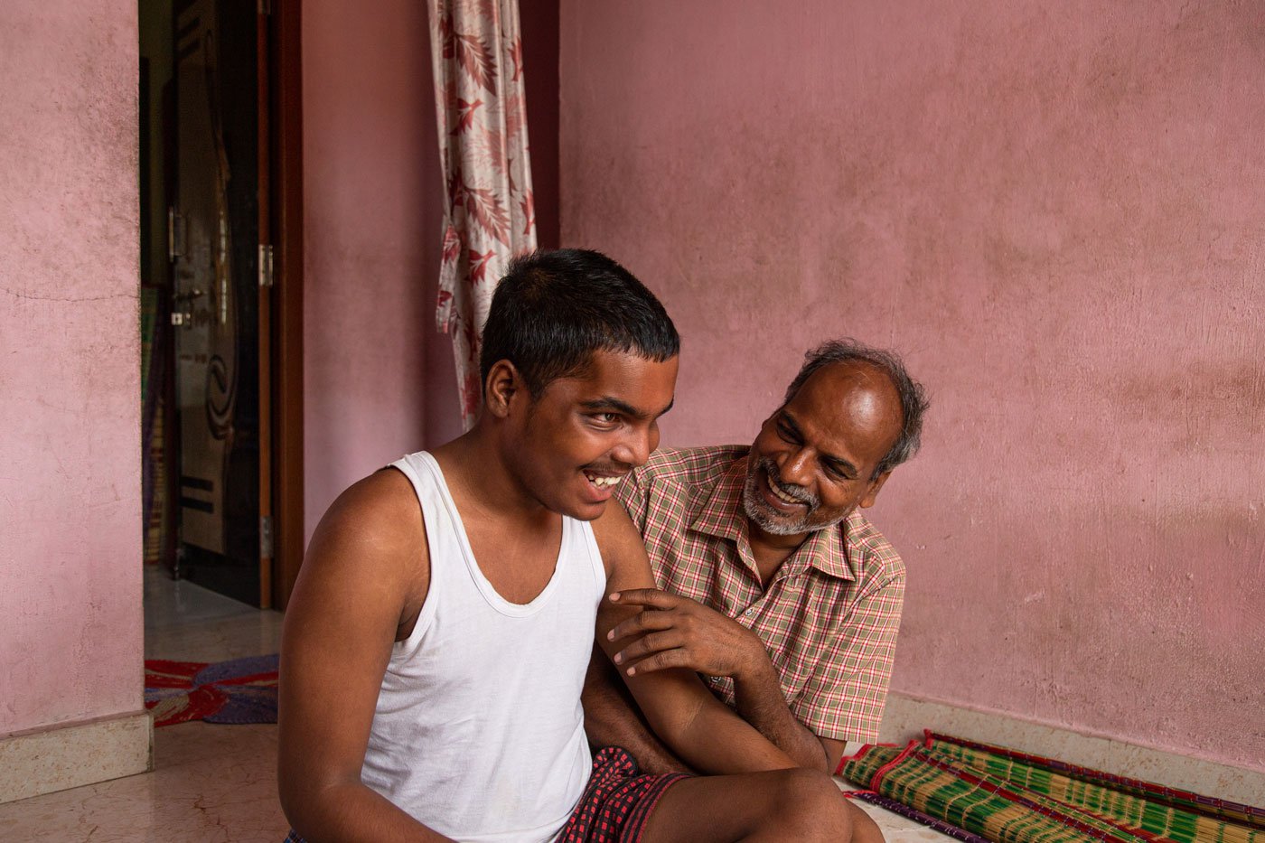 Balaraman is a loving grandfather and helps take care of the children. He works in a powerloom factory