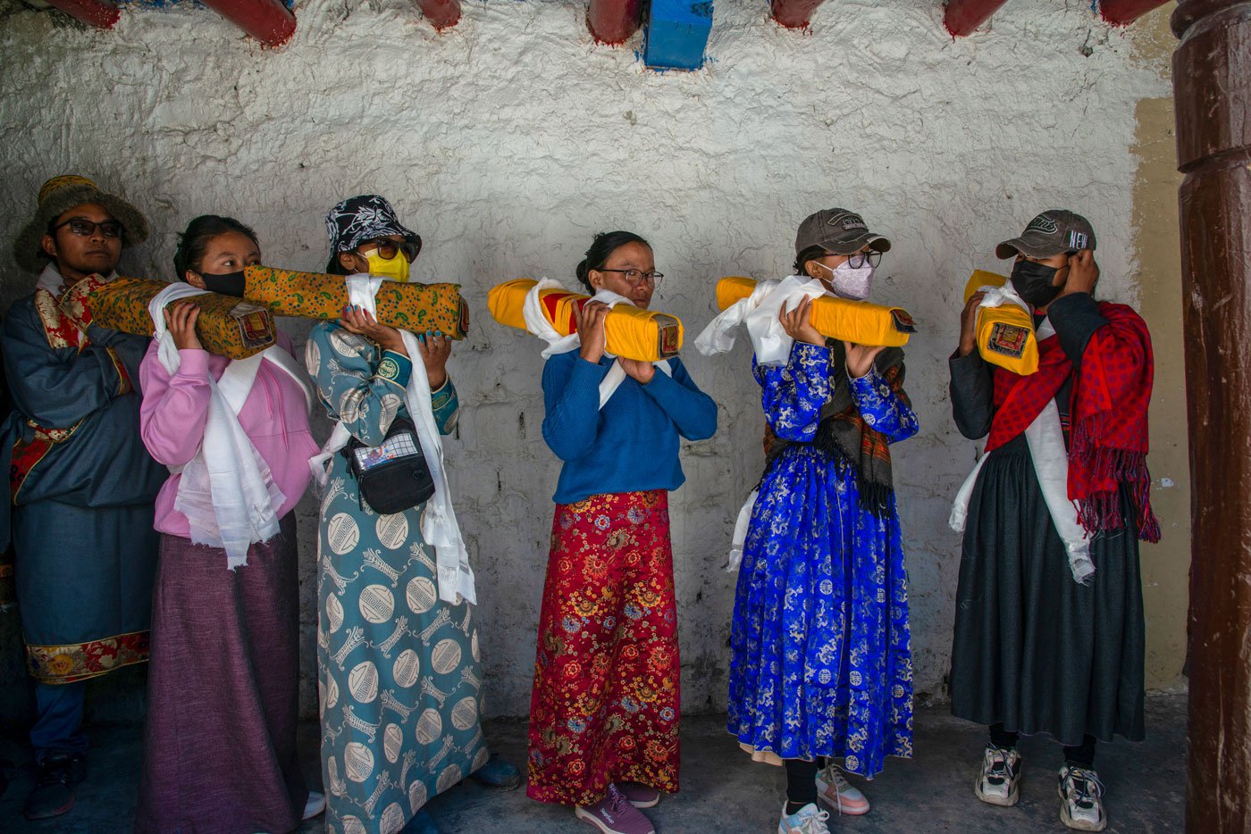 Women from different villages in Hanle River Valley carry the holy scrolls