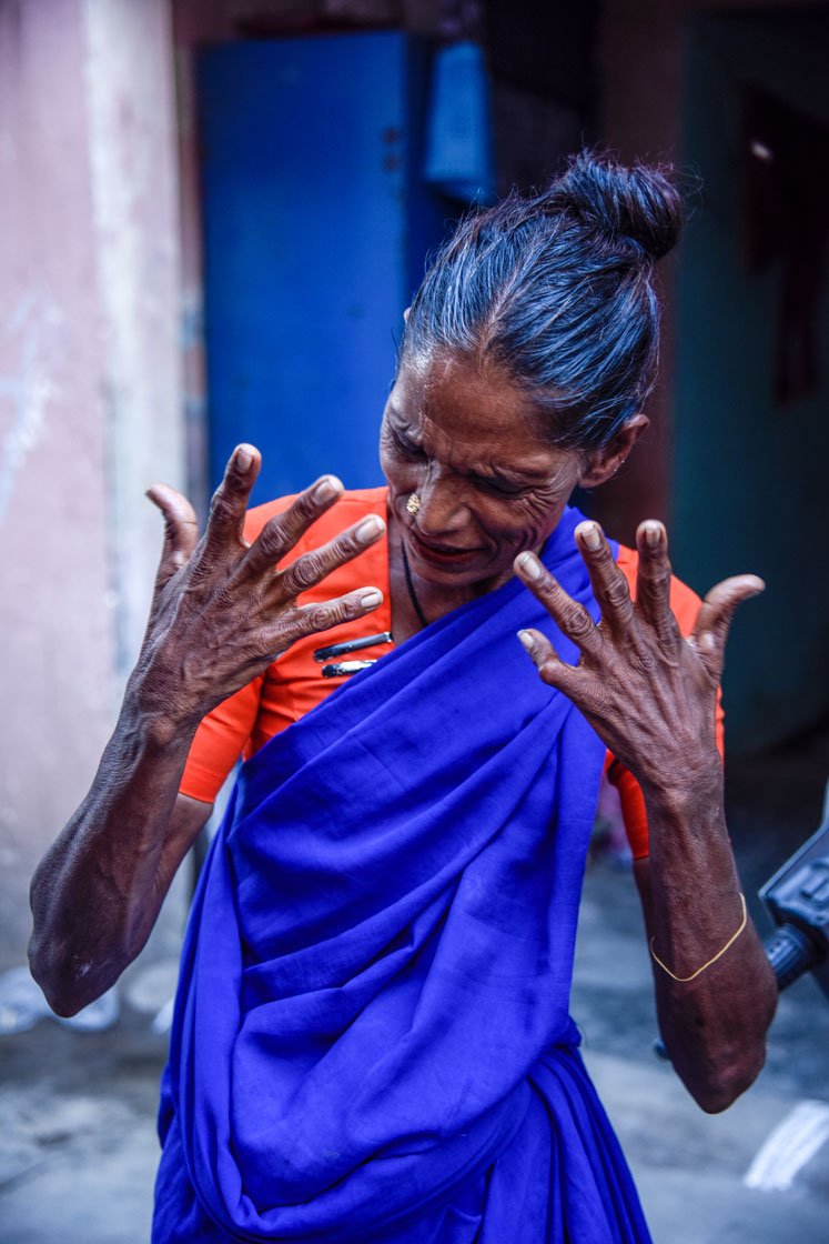 Using her hands and expressions, she communicates what she wants to say