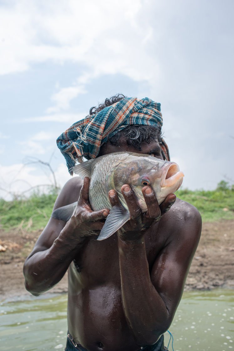 Raman (right) shows off his catch of a katla