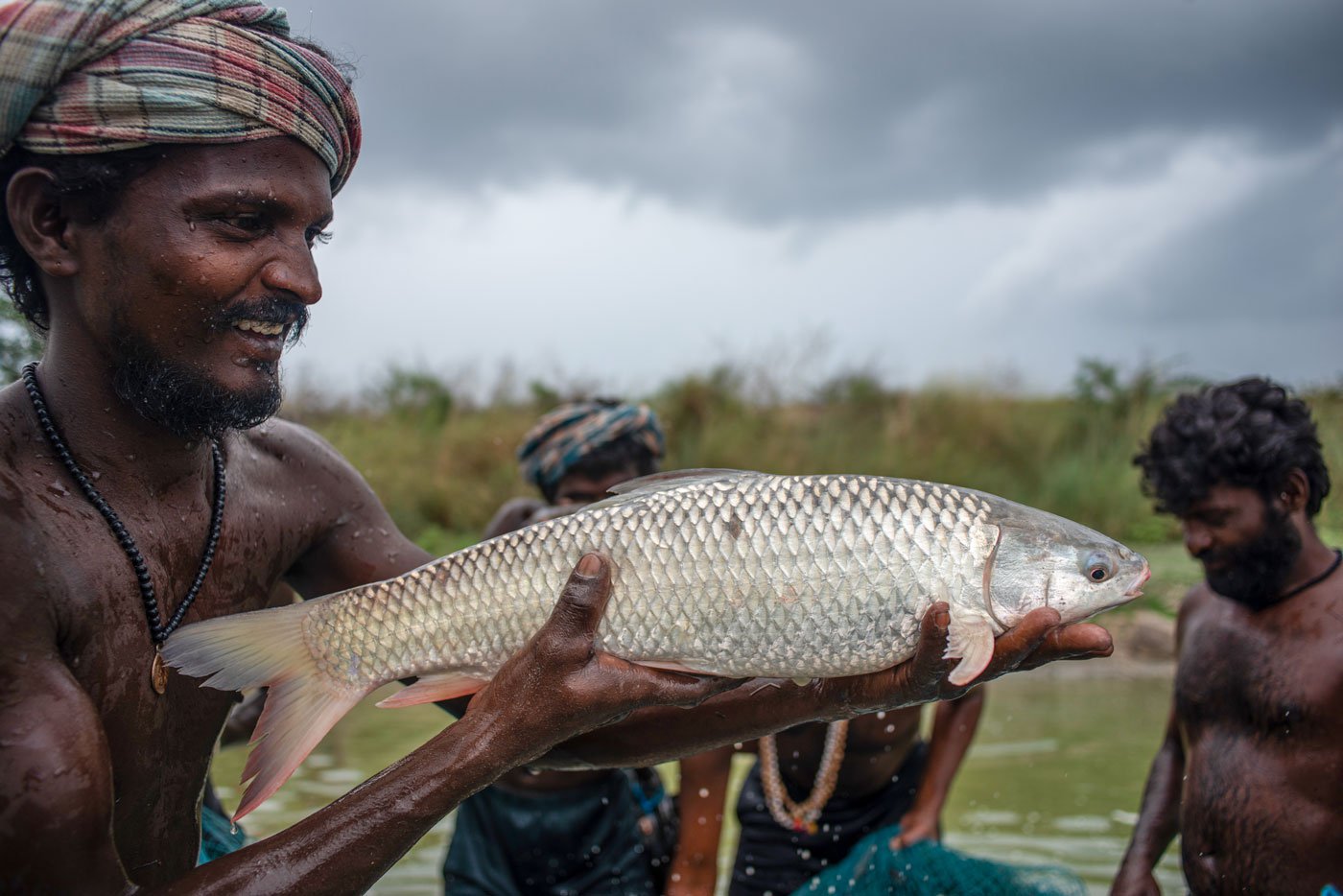 M. Marudhu holding the mullu rohu kenda fish in his hand