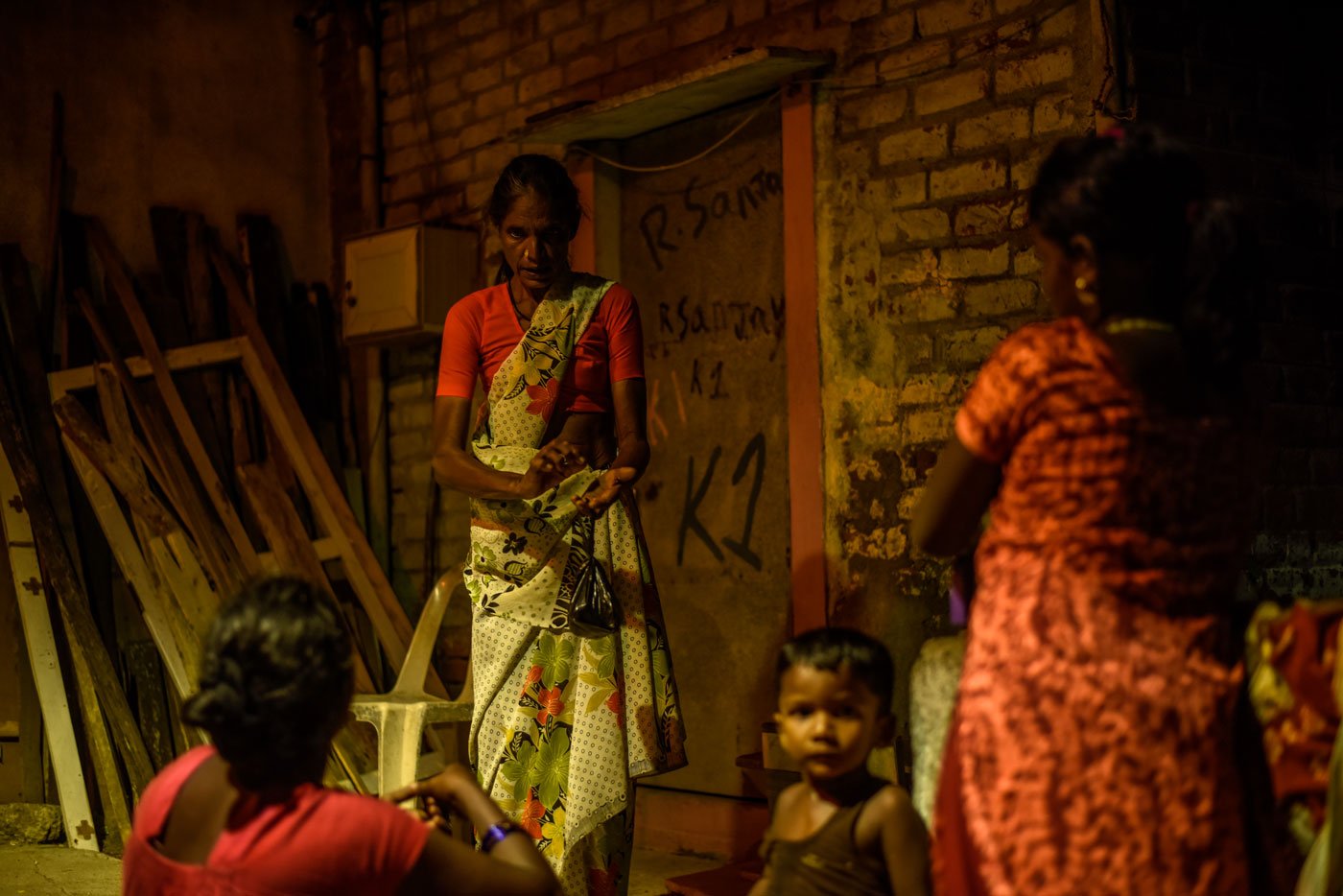 Left: Rita akka with her neighbours. Right: At home in the housing board quarters