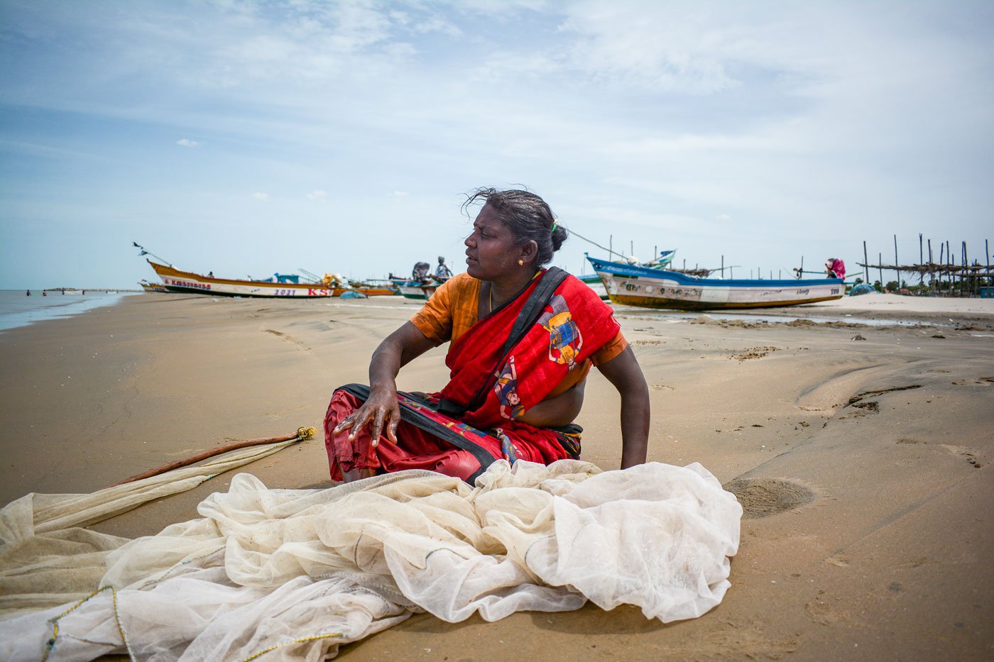 Kodiselvi relaxes on the shore in Vanavanmahadevi after collecting prawns from her nets.