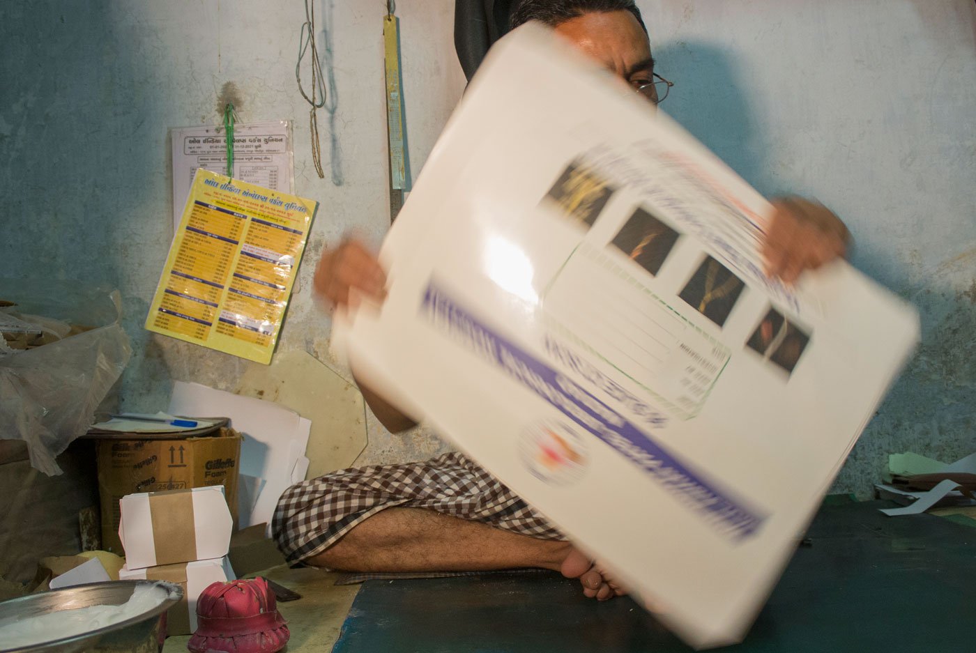 Abdul Muttalib Mohammad Ibrahim Ansari shows a large-size lamination cover that he has been making at Taj Envelopes