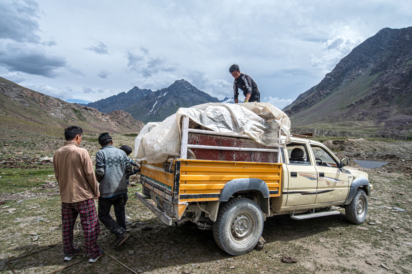 The pastoralists migrate back to their villages with their animals during winters. The family load the mini truck with dry yak dung to take back and use during winter