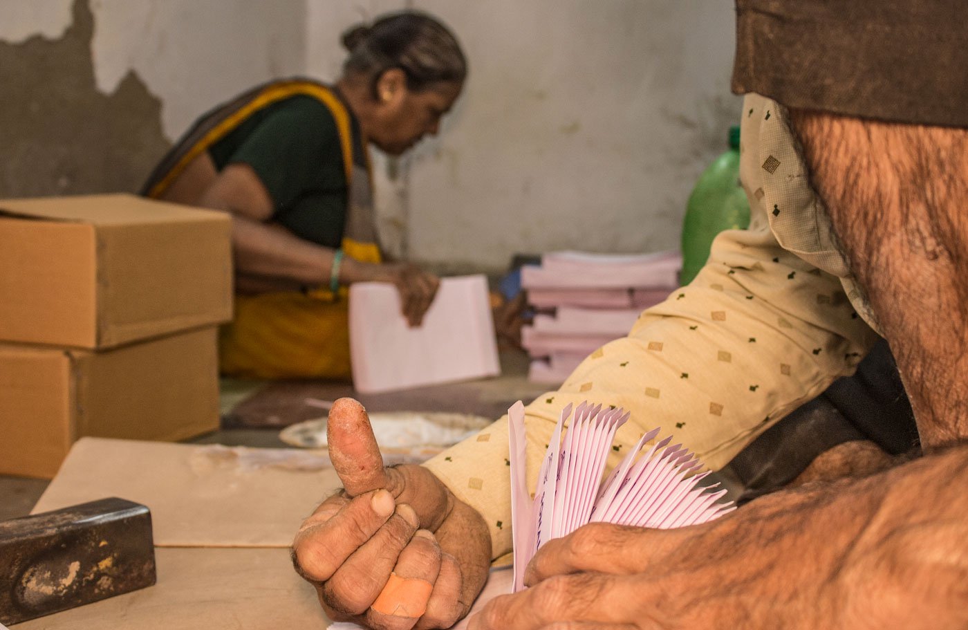 An envelope goes through 16 rounds in the hands of a worker during the entire process and the chances of getting your fingers cut, are high. Kaleem Sheikh shows his injured thumb