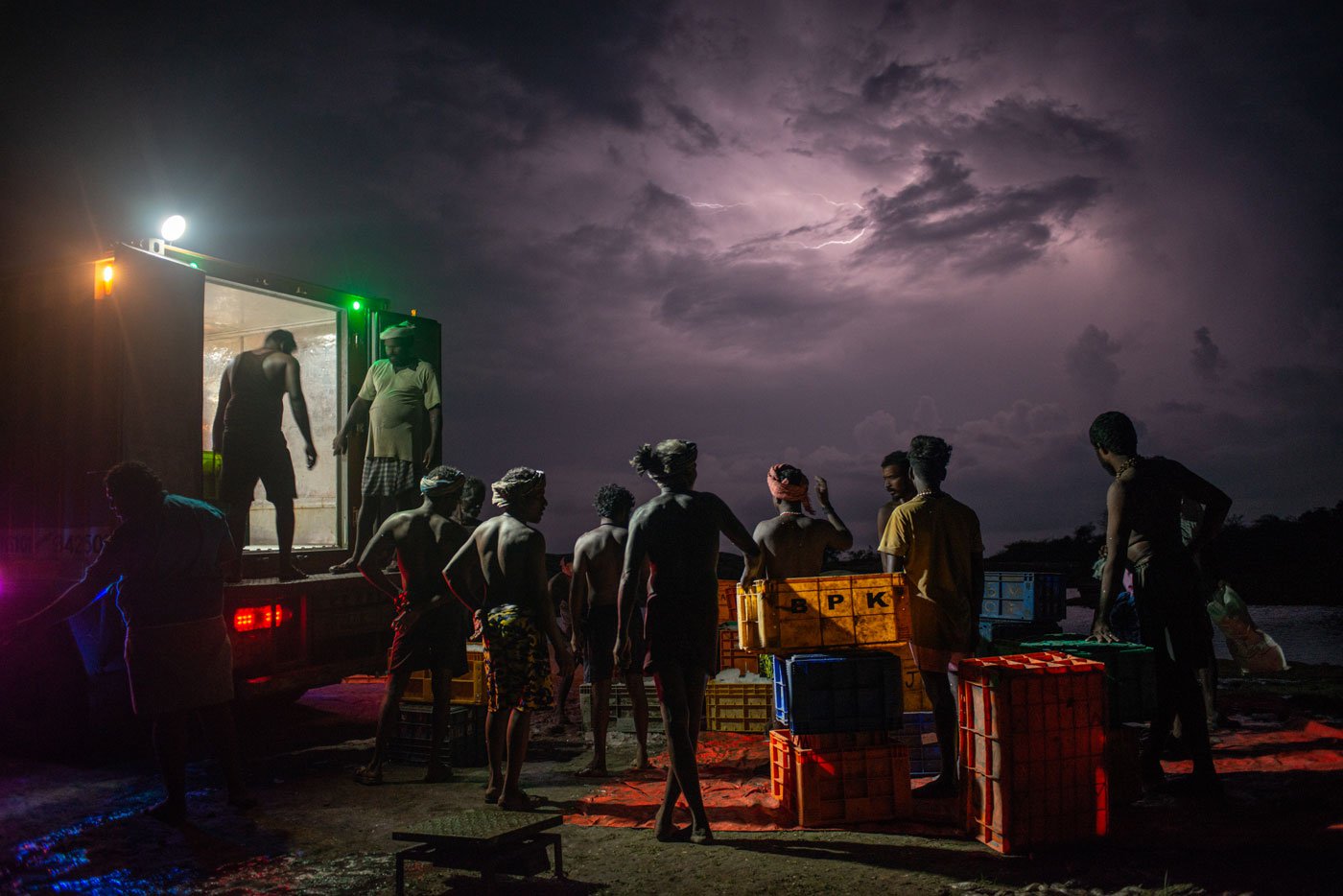 Ice boxes filled with catch being loaded into the truck in Kunnathur to be taken to the market