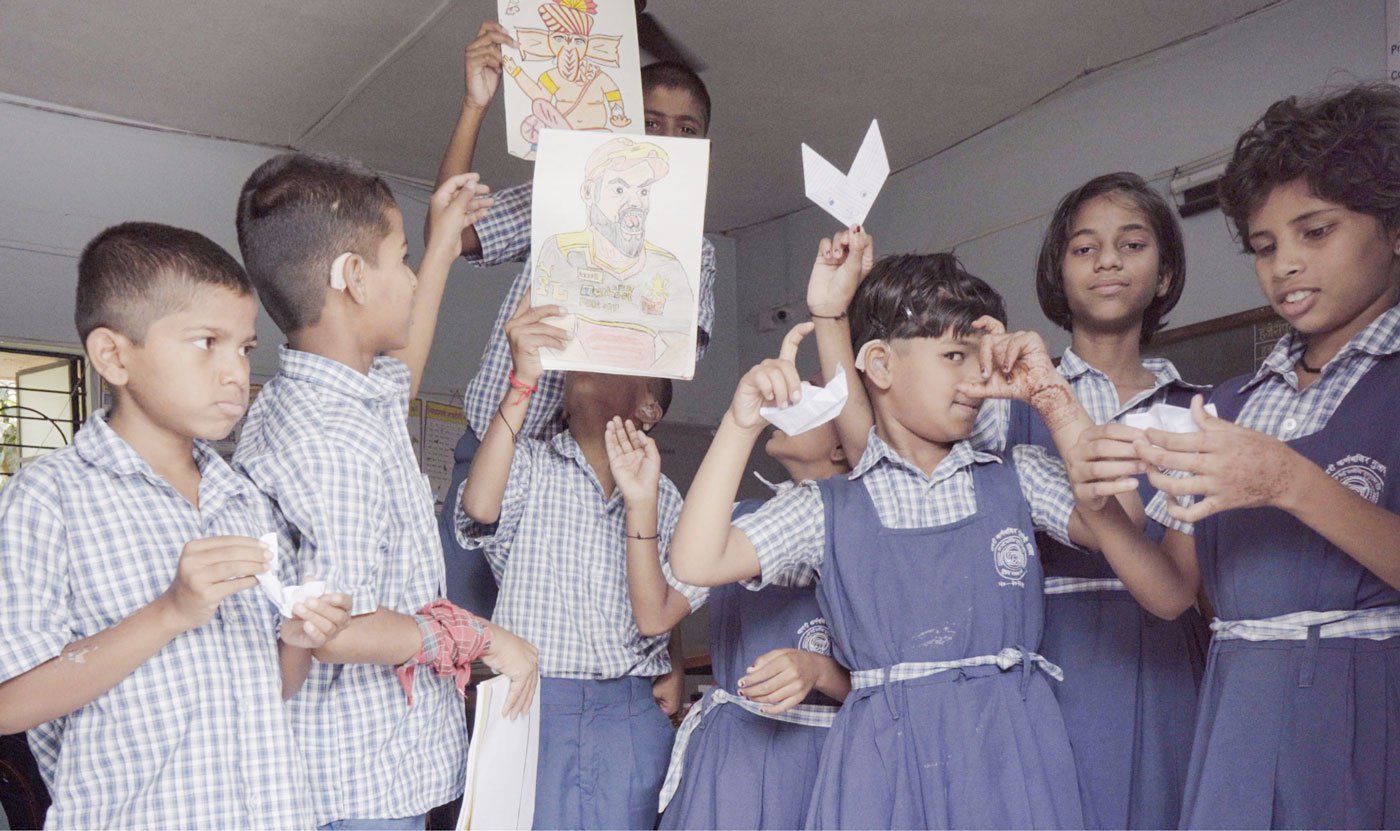 Children from Class 1 show paper bunnies, paper boats and other artwork