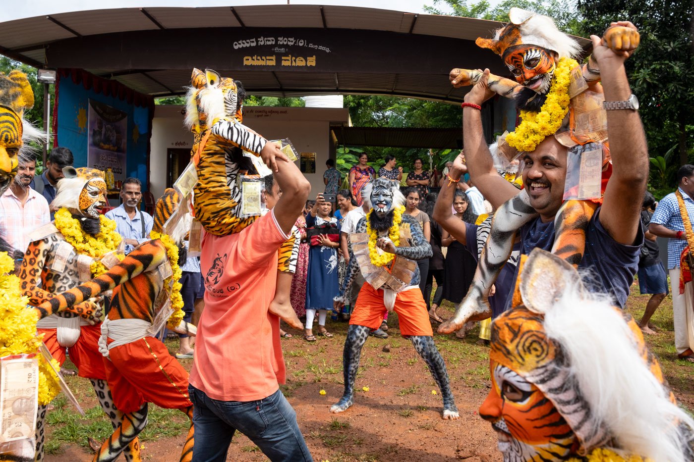 Villagers lift the young tiger dancers and dance to the drum beats