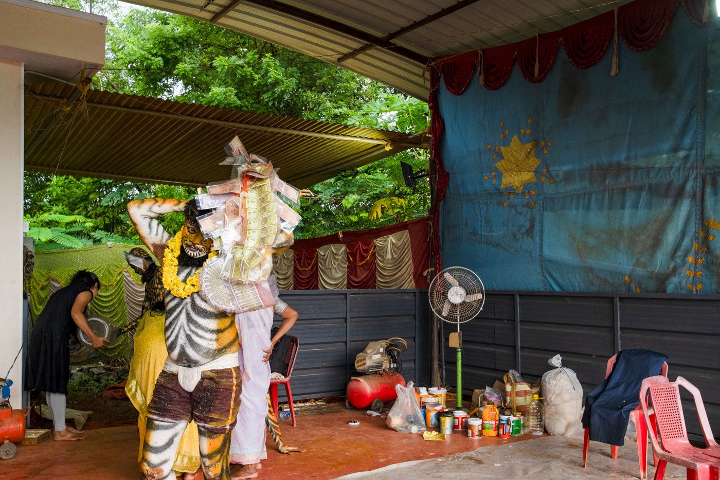 Virendra changing props after the first session of the performance. The 30-year-old works as a distributor at Amazon and encourages young people from his village to perform