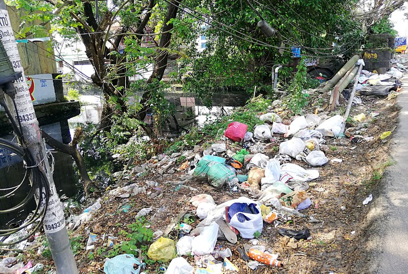 Left: A bridge on the canal that reduces its width and slows down the flow of water. Right: Waste dumped by Kochi city residents on the canal banks