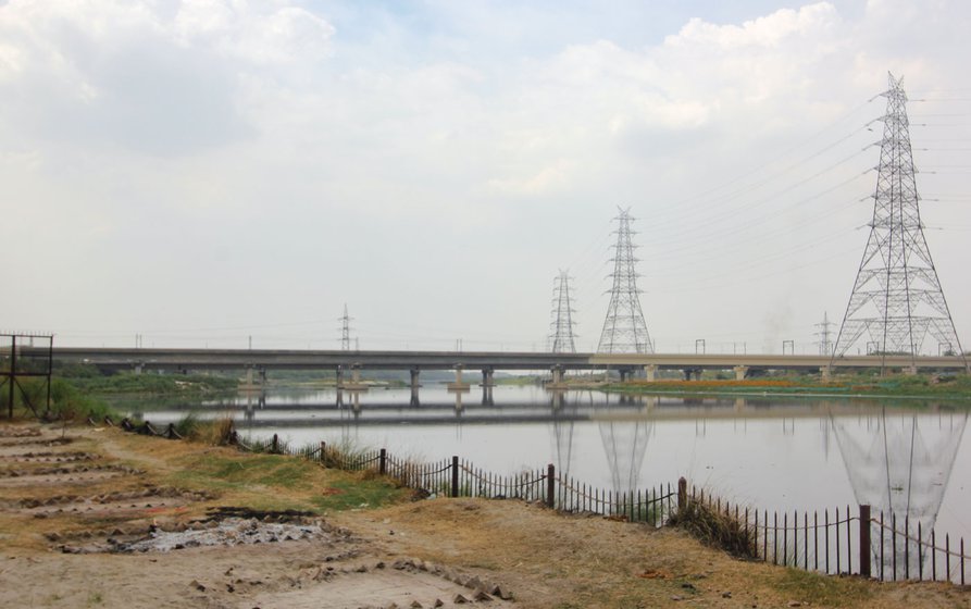 Left: New spots created for pyres at Nigam Bodh Ghat on the banks of the Yamuna in Delhi. Right: Smoke rising from chimneys of the CNG furnaces