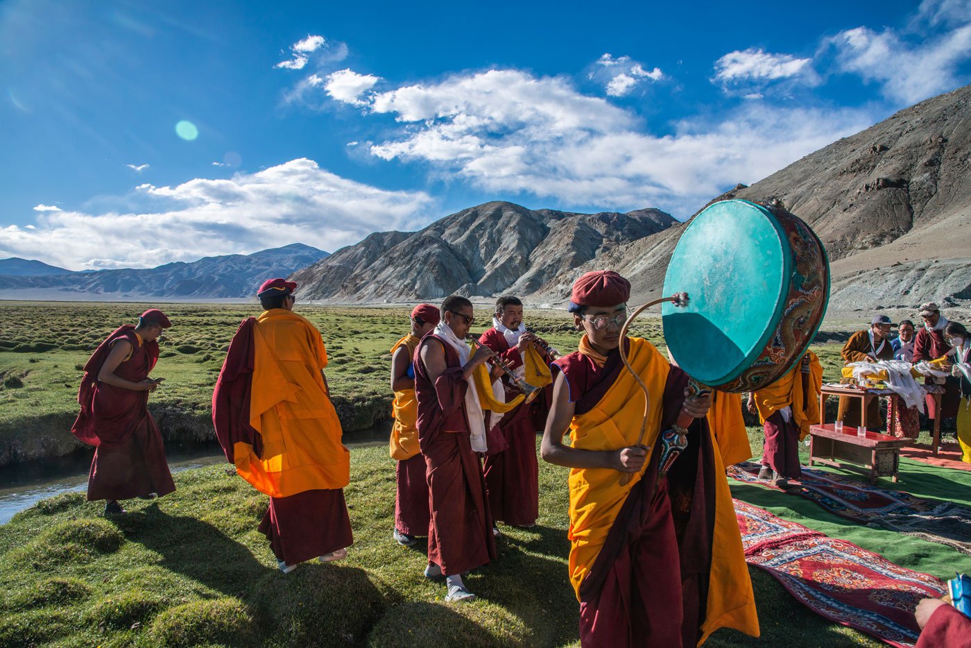 After circling every village on their route, the convoy finally stops at a beautiful grassland near Naga. The residents of this village are of Tibetan origin. With the beating of drums, the lamas declare the journey over