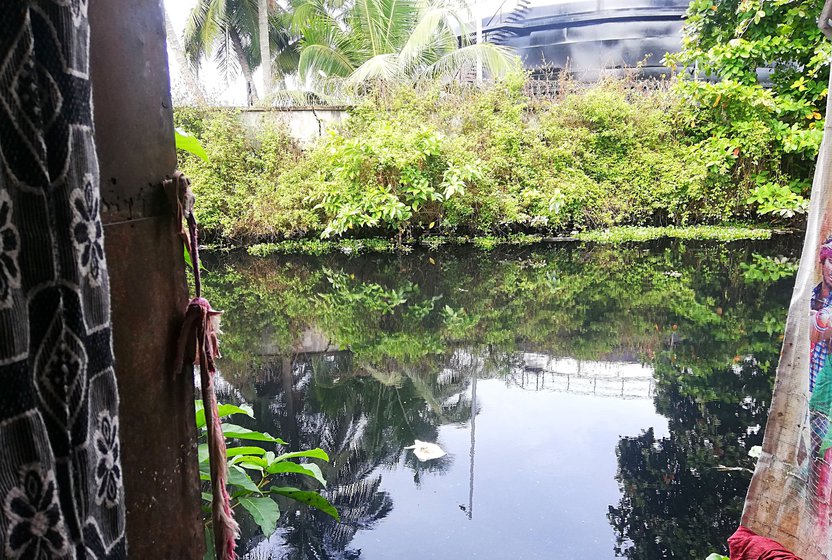 'I have woken up many times to find water flooding my home', says Sathi; she and her husband Mani live next to this canal where all the waste of the area is dumped