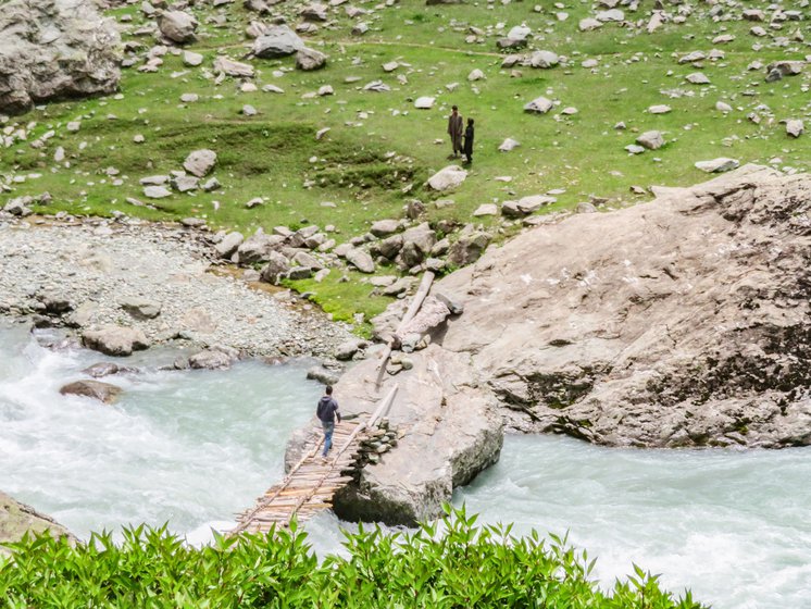 The green tent is the school tent. Right: Ali and two students crossing the Lidder river on the wooden bridge. He will teach here in the afternoon