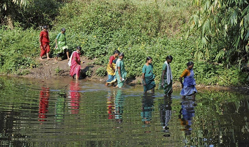 Tribal women crossing water body