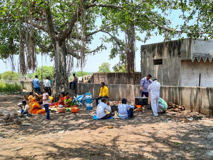 Right: A banyan tree provides some shade and respite to the families who are cooking the meat, as well as families waiting to offer nivad and prayers at the dargah