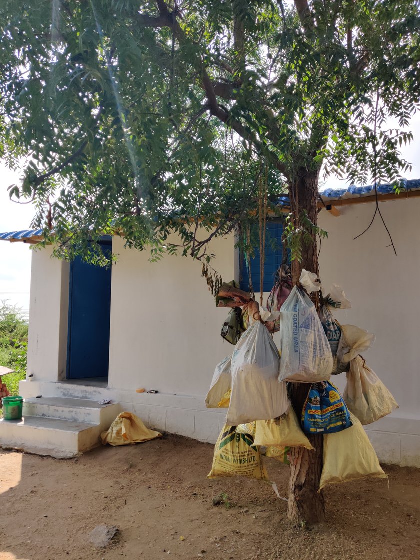 Left: Sacks containing vessels for the menstruating women are hung from the branches of a neem tree that stands between the two isolated rooms in Koovalapuram village. Food for the women is left in these sacks to avoid physical contact. Right: The smaller of the two rooms that are shared by the ‘polluted’ women