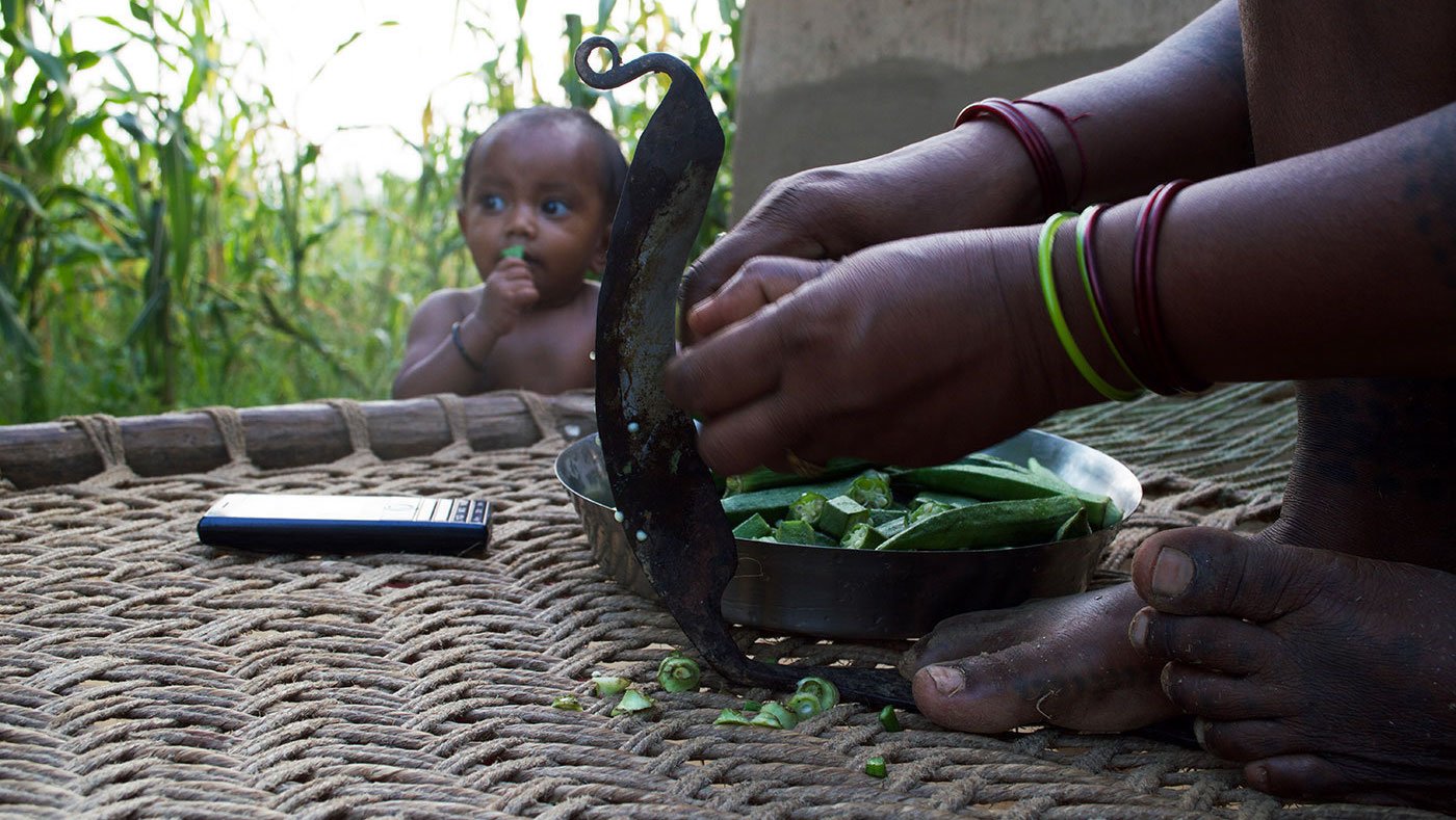 Close up of woman cutting okra on round blade