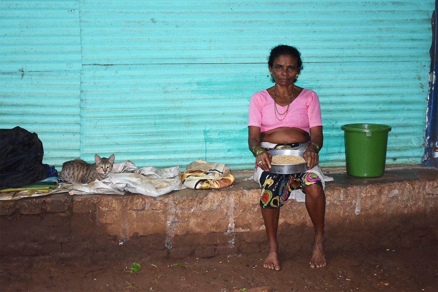 A women sitting in front her house