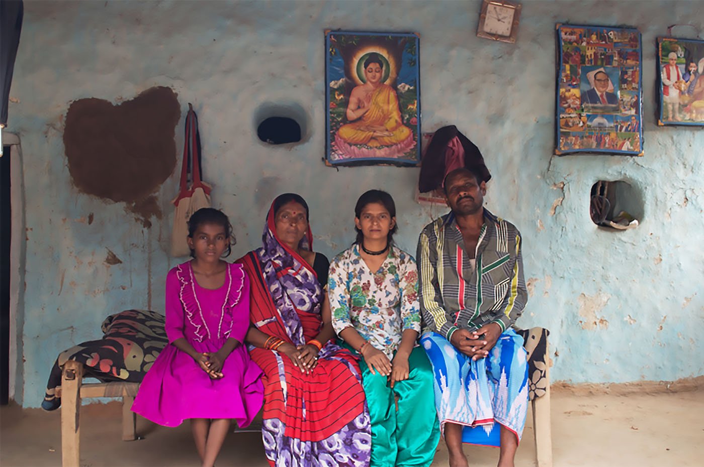 Family sitting on cot 