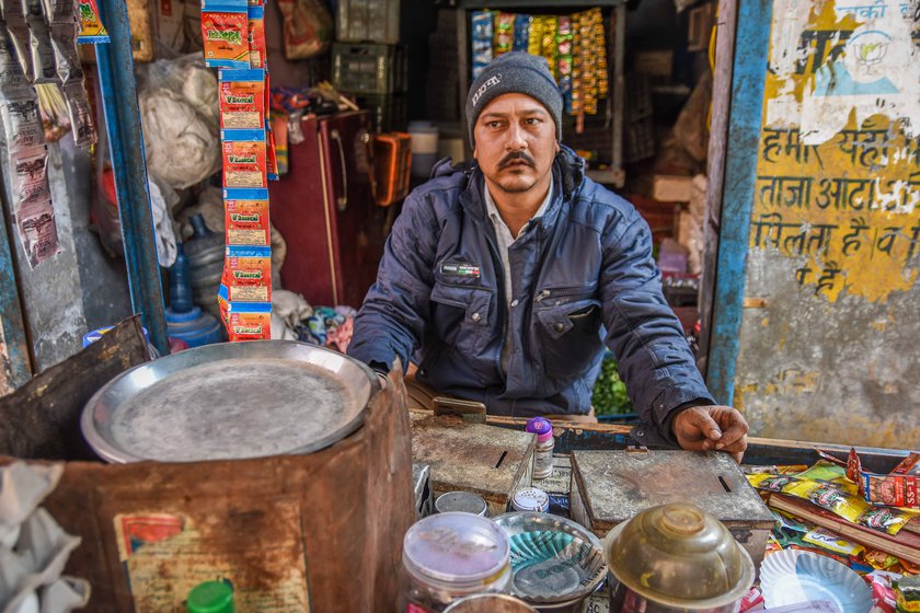 Left: Nizamuddin Ali, a security supervisor at a factory near the Singhu site, has not received his salary for over two months, but still supports the protesting farmers. Right: Mahadev Tarak, whose income has halved from his stall selling cigarettes and tea, says, 'We don't have any problems if the farmers stay here'