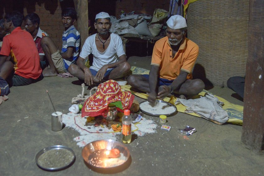 Kalu Jangali (left, in a white vest)  had confirmed the diagnosis – Nirmala (centre) had jaundice. But, he said, 'She was also heavily under the spell of an external entity', which he was warding off along with fellow bhagat Jaitya Digha during the jagran ceremony in Chikanpada hamlet