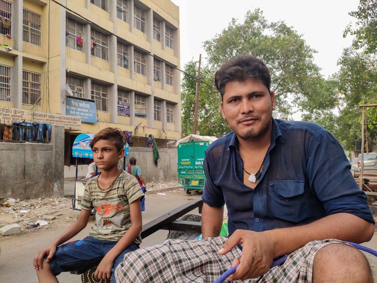 'We know the price we pay for living with tradition. But we love our oxen. They are our family', says Vijay Kumar Singh, siting on the cart (left); he   never went to school, but wants his son Rajesh (right) to get a good education