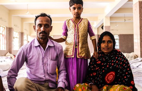 Young girl with parents at Bijwasan Barat Ghar