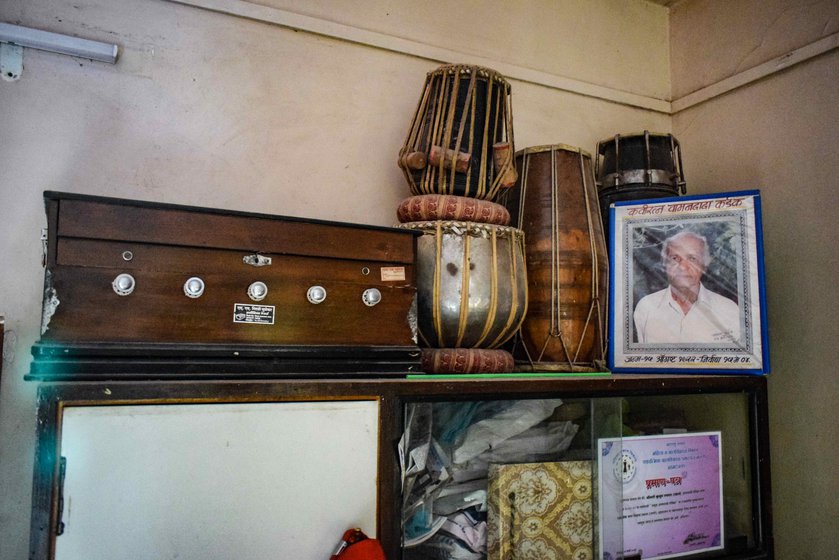 In Dadu Salve's home in Ahmednagar is a framed photo of his guru, the legendary Bhim Shahir Wamandada Kardak , and his musical instruments: a harmonium, tabla and dholaki.