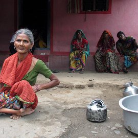 Old woman with her family with empty vessels