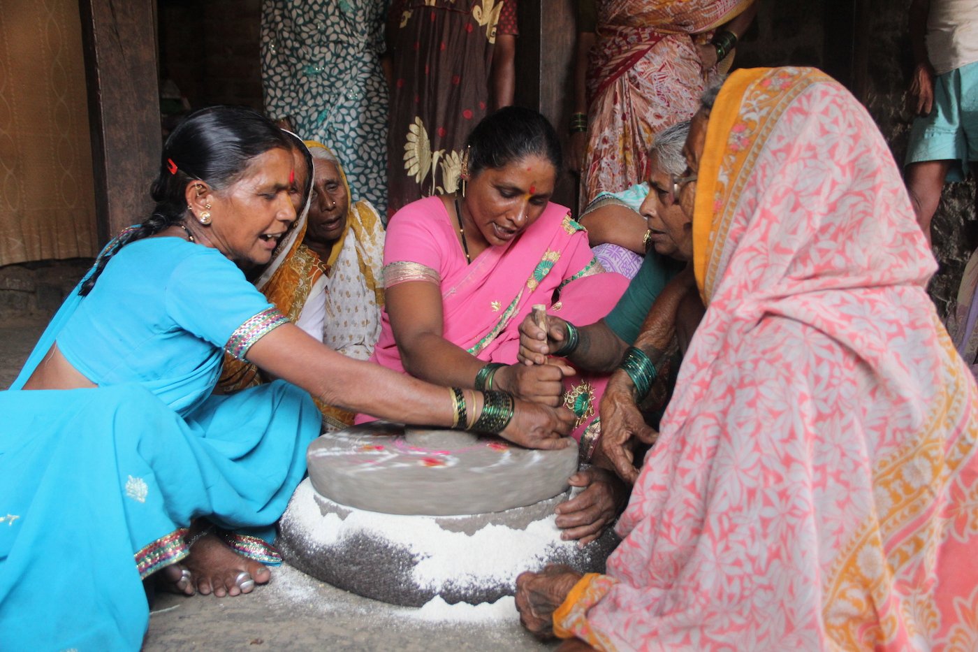 Women sitting by the grinding stone