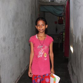 Kashish Ahaldhiya standing in a corridor