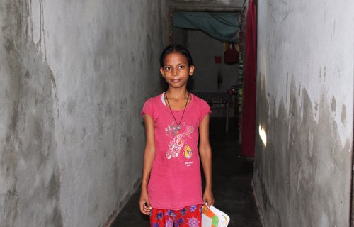 Kashish Ahaldhiya standing in a corridor