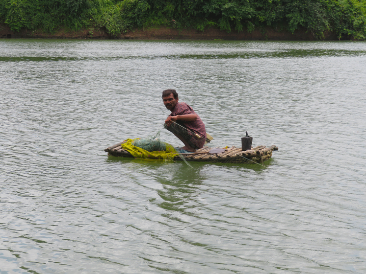 A man in a boat, catching fishes  