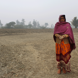 Mula standing in an abandoned land at her village