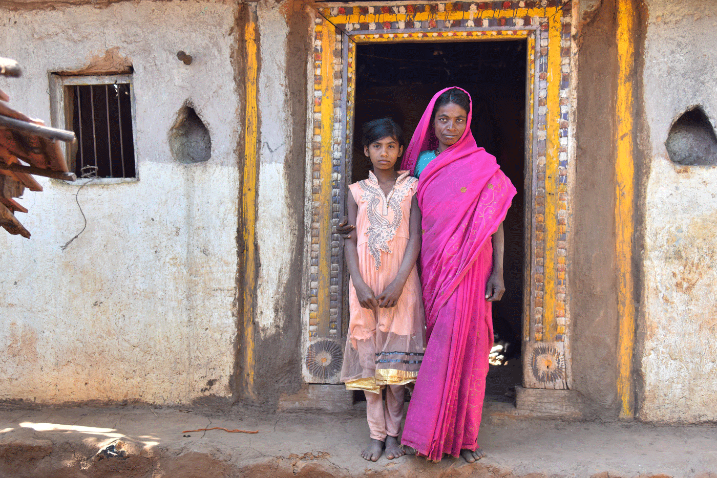 Two women in front of a house