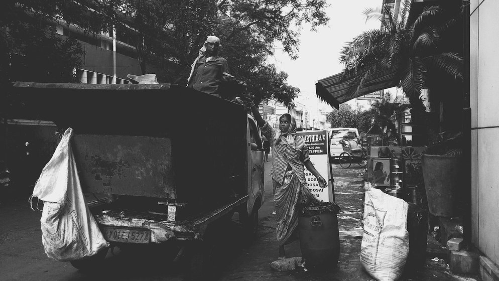 At dawn, the garbage is loaded on to trucks